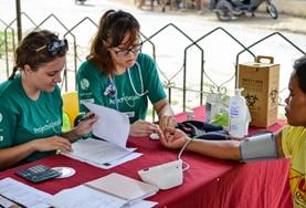 Volunteer Philippines Public Health volunteers assist a patient at a outreach in the Philippines