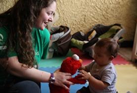 Volunteer Costa Rica A volunteer plays with a child using a soft toy at our Care placement in Costa Rica.