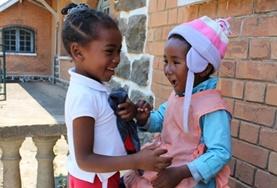 Volunteer Madagascar Two children laugh together at one of our childcare placements in Madagascar.