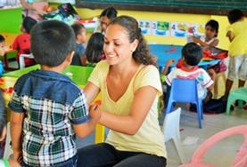Volunteer Philippines A volunteer plays an interactive game with a young boy at one of our childcare placements in the Philippines.