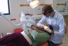 Volunteer Medical Electives A dentist examines the teeth and gums of a patient