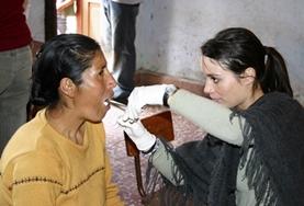 Volunteer Peru A dentistry student volunteering in Peru examines a patient's teeth as part of her elective work.