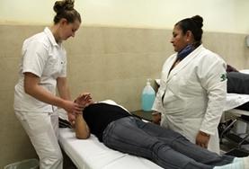 Volunteer Mexico A local staff member supervises as a Nursing Elective intern works with a patient at a hospital in Mexico.