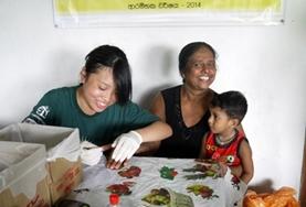 Volunteer Sri Lanka A Nursing Elective intern prepares to do a healthcare screening on a local child in Sri Lanka.