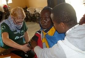 Volunteer Tanzania A Nursing student measures a local women's blood pressure as part of her elective work in Tanzania.