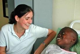 Volunteer Ghana A Dentistry intern volunteering in Ghana spends time with a patient after a dental procedure.
