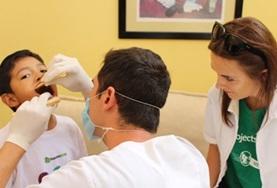 Volunteer Mexico A Dentistry intern observes as a dentist performs a check-up on a boy in Guadalajara, Mexico.