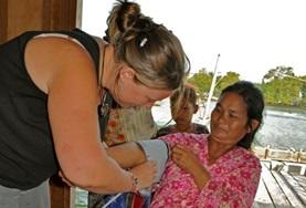 Volunteer Medicine & Healthcare A volunteer checks a patient's blood pressure while on a Medicine placement in Cambodia