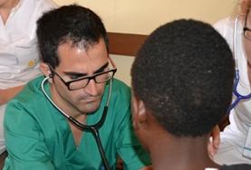 Volunteer Jamaica A Medicine volunteer checks a child's heart rate during a healthcare screening outreach in Kenya.