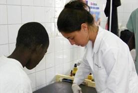 Volunteer Senegal A Medicine intern in Senegal gains important work experience removing a bandage from a child's leg.