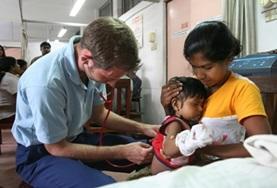 Volunteer Sri Lanka A Medicine volunteer performs a general check-up on a young child during a healthcare screening in Sri Lanka.