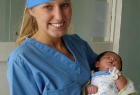 Volunteer Medicine & Healthcare A Midwifery volunteer holds a newborn at her placement in Mongolia