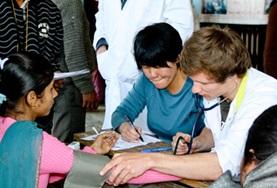 Volunteer Medicine & Healthcare Nursing volunteers work with a patient at a placement in Nepal
