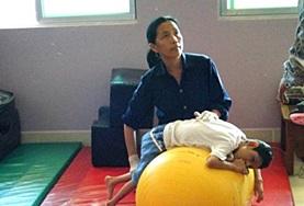 Volunteer Cambodia A local Physiotherapist demonstrates a treatment technique to Physiotherapy interns at our volunteer placement in Cambodia.