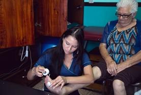 Volunteer Costa Rica A Physiotherapy intern works with an elderly patient in Costa Rica, stretching her muscles and helping to strengthen her legs.