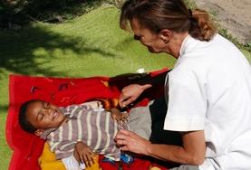 Volunteer Ethiopia A young child at our volunteer Physiotherapy placement in Ethiopia uses bars to support himself as he exercises his legs.