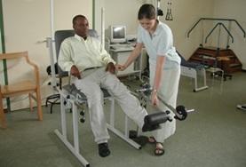 Volunteer Ghana A Physiotherapy intern in Ghana uses a weights machine to exercise a patient's leg muscles at a local hospital.