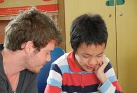 Volunteer Vietnam A Speech Therapy volunteer works on a language task with a disabled boy at our internship in Vietnam.