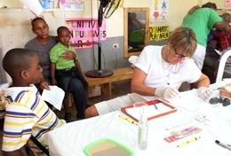 Volunteer Medicine & Healthcare A Dentistry volunteer prepares to inspect a patient on a public outreach