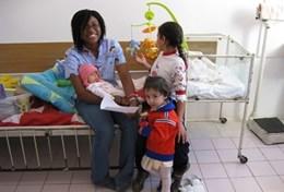 Volunteer Medicine & Healthcare A volunteer Massage Therapist poses with children at a placement in Romania