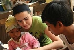 Volunteer Medicine & Healthcare A volunteer interacts with two children during an Occupational Therapy session