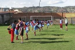 Volunteer Peru A professional Physical Education Teacher leads school children through a stretching class at his volunteer placement in Peru.