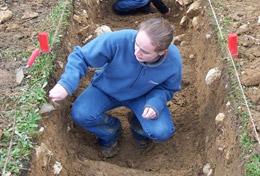 Volunteer Archaeology An Archaeology volunteer inspects the ground at a placement in Romania