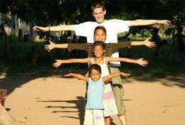 Volunteer Care A Volunteer and children pose for a picture at a Care and Community Placement in Cambodia