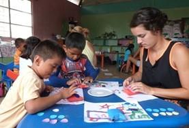 Volunteer Ecuador A high school student volunteering in Ecuador runs an art class with children from a local care centre, teaching them new skills in a creative way.