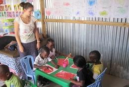 Volunteer Care A High School Special volunteer holds an art class to teach children at a daycare centre in South Africa how paint.