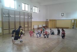 Volunteer Romania A Football volunteer leads a sports team in Romania through a stretching routine before they start their practice.