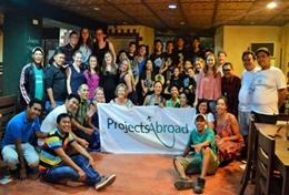 Volunteer Philippines School Sports volunteers and local Projects Abroad staff pose with a team of sports players in the Philippines.