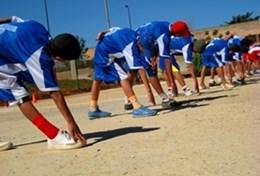 Volunteer Sri Lanka Young athletes stretch before a race on a running track at our volunteer Athletics placement in Sri Lanka.