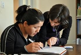 Volunteer Teaching A Teaching volunteer assists a student with work at a placement in Bolivia