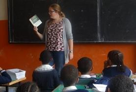 Volunteer Ethiopia A volunteer reads an English book with her class at our Teaching placement in Ethiopia.