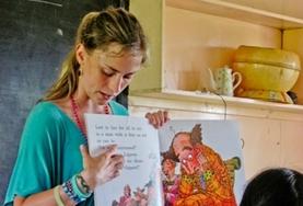 Volunteer Fiji A Teaching volunteer points to the words as she read an English book to school children in Fiji.