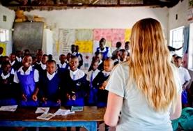Volunteer Kenya A volunteer teaches an interactive English lesson to a class of school children at our placement in Kenya.