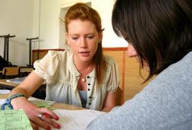 Volunteer Romania Teaching volunteers in Romania work together on a lesson plan to teach English to children at a local school.
