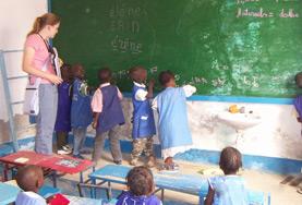 Volunteer Senegal School children in Senegal work together to solve a problem on the blackboard at out volunteer Teaching placement in Senegal.