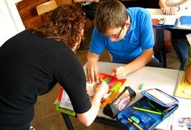 Volunteer Teaching A volunteer French Teacher assists a student on a placement in Romania