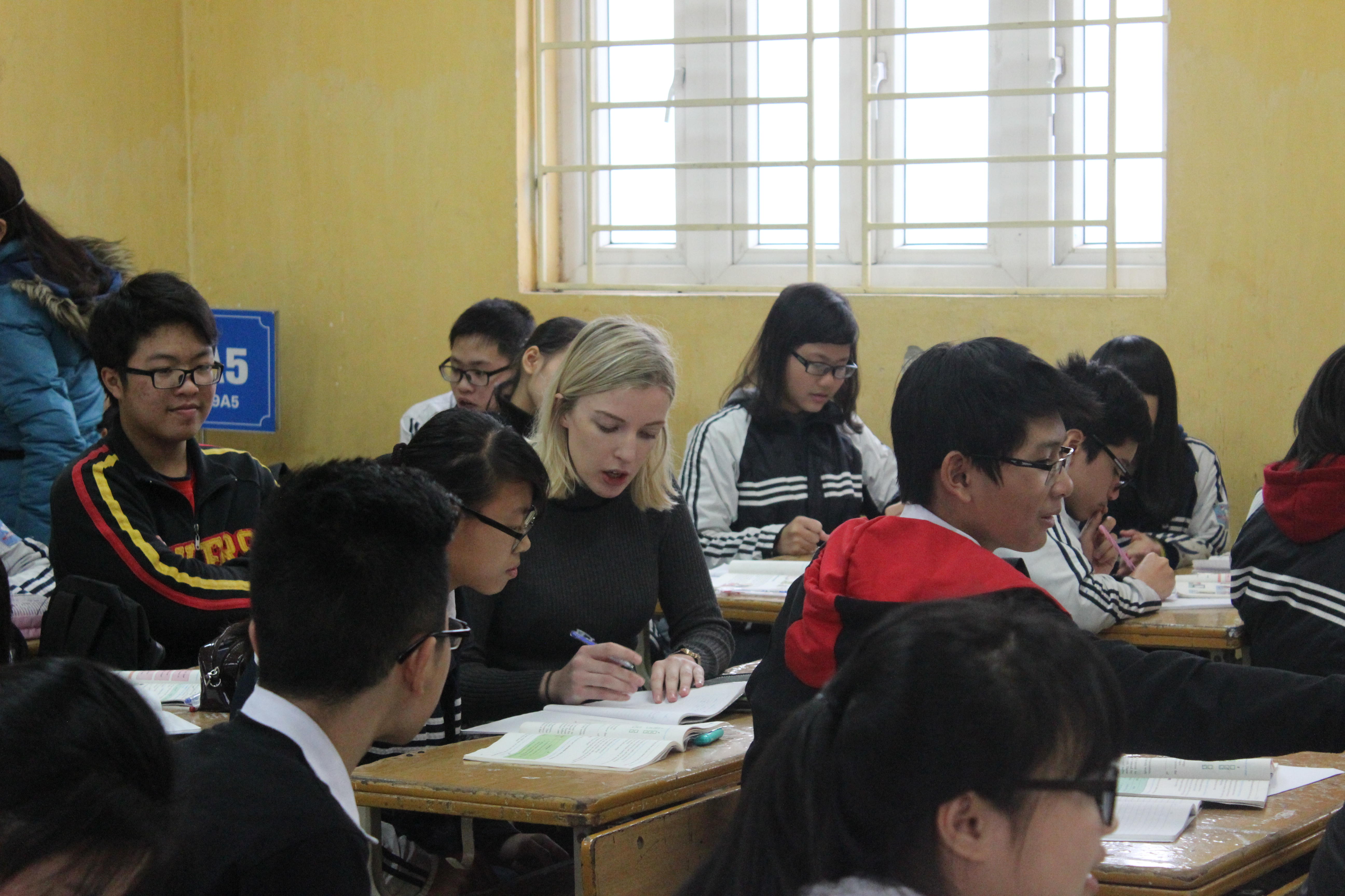Volunteer Teaching A volunteer French teacher assists a student during a lesson at a placement in Vietnam
