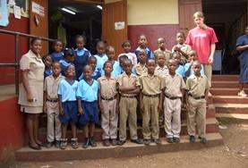 Volunteer Teaching IT students pose for a picture with their volunteer Teacher
